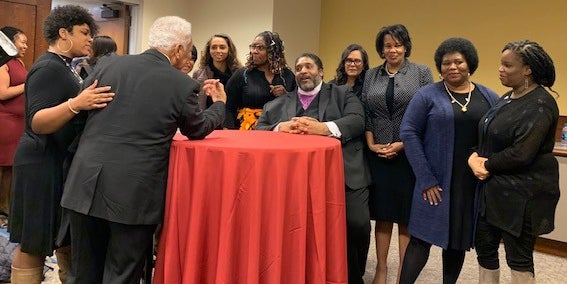 Reverend Dr. Wiliam Barber II attending a reception with large group