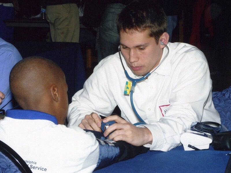health care professional testing someone's blood pressure